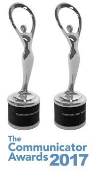 Two Communicator Award statues with text.