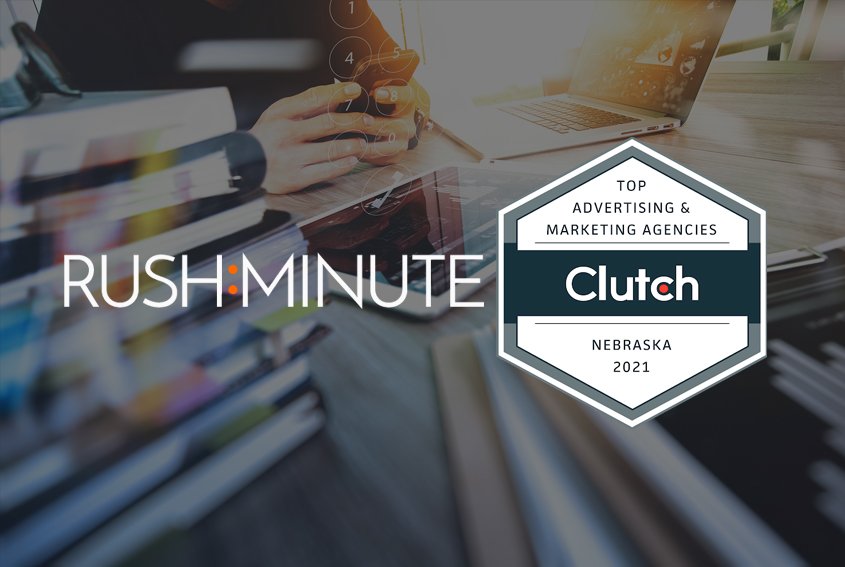 Rushminute logo and Clutch Award over image of web designer