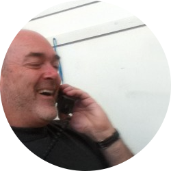 Photo of Rushminute founder Robbie Moore on telephone.