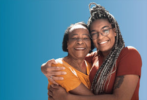 mother and daughter hugging in front of blue background